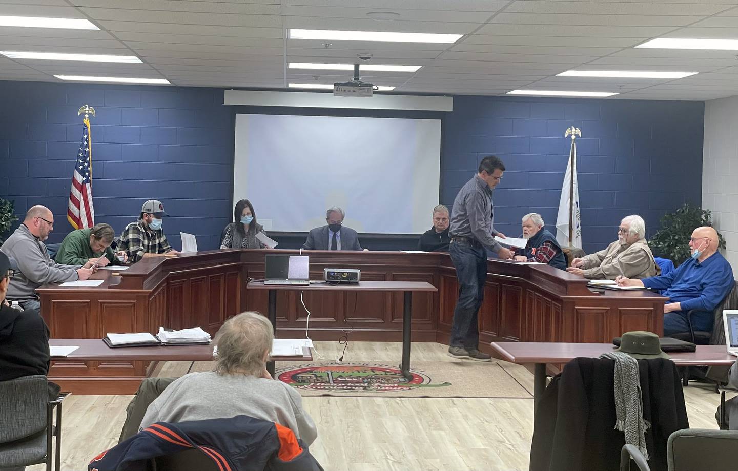 Village Engineer Kevin Heitz gives the Utica Planning Commission a handout of the drawing of a newly proposed "The Shoppes of Mini Mill Street" at the Village Hall on Thursday Jan. 27, 2022.