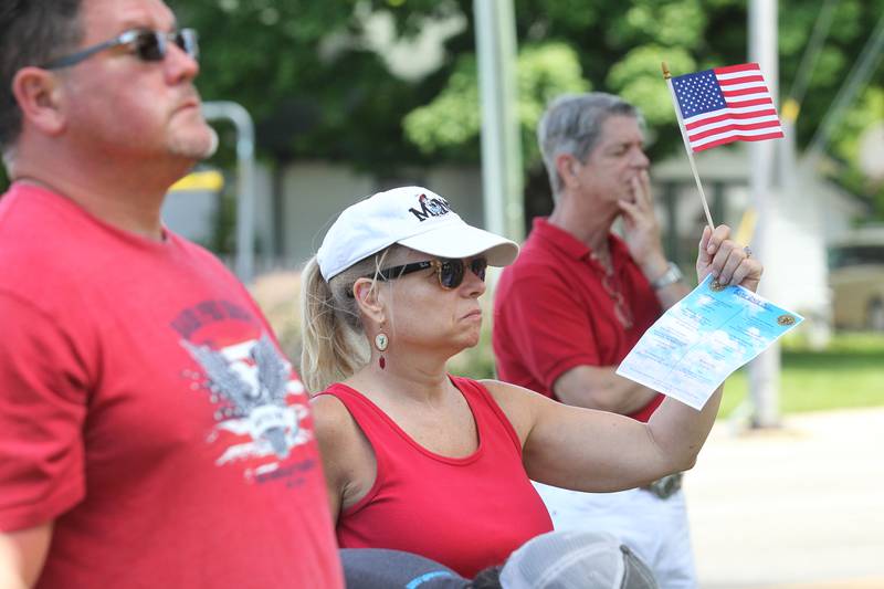 Marty Garcia, of Wauconda, stands next to Daina Ward, of Bartlett, as they listen to the speakers Monday, May 29, 2023, at the Wauconda Memorial Day Ceremony in Memorial Park.