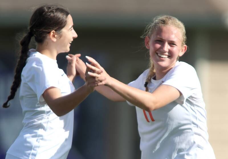 Crystal Lake Central’s  Madeline Gray, right, is congratulated by Addison Schaffer, left, after Gray scored in varsity soccer at Hampshire Tuesday evening.