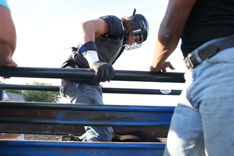 Dominic Dubberstine-Ellerbrock mounts the bull before his ride. Dominic will be competing in the 2022 National High School Finals Rodeo Bull Riding event on July 17th through the 23rd in Wyoming. Thursday, June 30, 2022 in Grand Ridge.