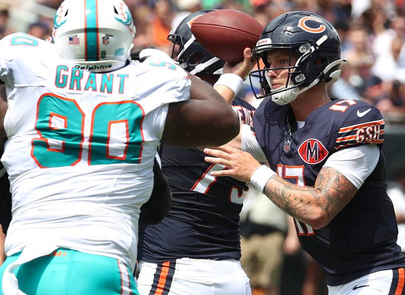 Chicago Bears quarterback Tyson Bagent gets rid of the ball just ahead of the pressure of Miami Dolphins defensive tackle Kenneth Grant Sunday, Aug. 10, 2025, during their preseason game at Soldier Field in Chicago.
