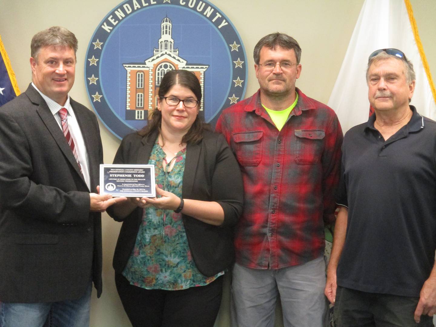 The Kendall County Historic Preservation Commission honored the late Stephenie Todd with a lifetime achievement award at the May 16, 2023 Kendall County Board meeting. From left are County Board Chairman Matt Kellogg, Todd's daughter Julie Rogers, son Tom Todd and Preservation Commission Chairman Jeff Wehrli.