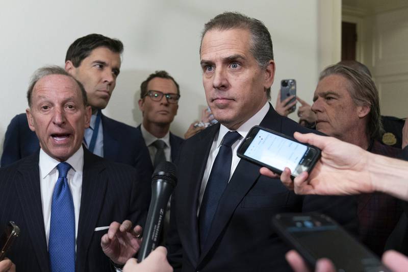 Hunter Biden, President Joe Biden's son, accompanied by his attorney Abbe Lowell, left, talks to reporters as they leave a House Oversight Committee hearing as Republicans are taking the first step toward holding him in contempt of Congress, Wednesday, Jan. 10, 2024, on Capitol Hill in Washington.