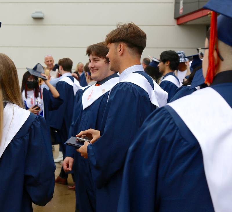 Oswego High School graduates step out into the rain after their graduation ceremony on Saturday, May 21, 2022 in DeKalb.