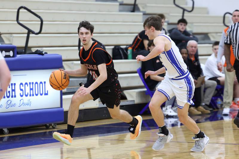 Beecher's Dominick DeFrank brings the ball up against Peotone's Nate Wehrmann during the Blue Devils' 64-52 victory over Beecher on Wednesday, Jan. 28, 2026.
