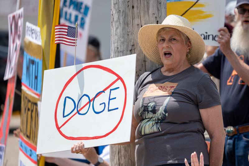 Protester holds sign and chants at the “No Kings” protest on Saturday, June 14, 2025 at Rotary Park in Princeton.
