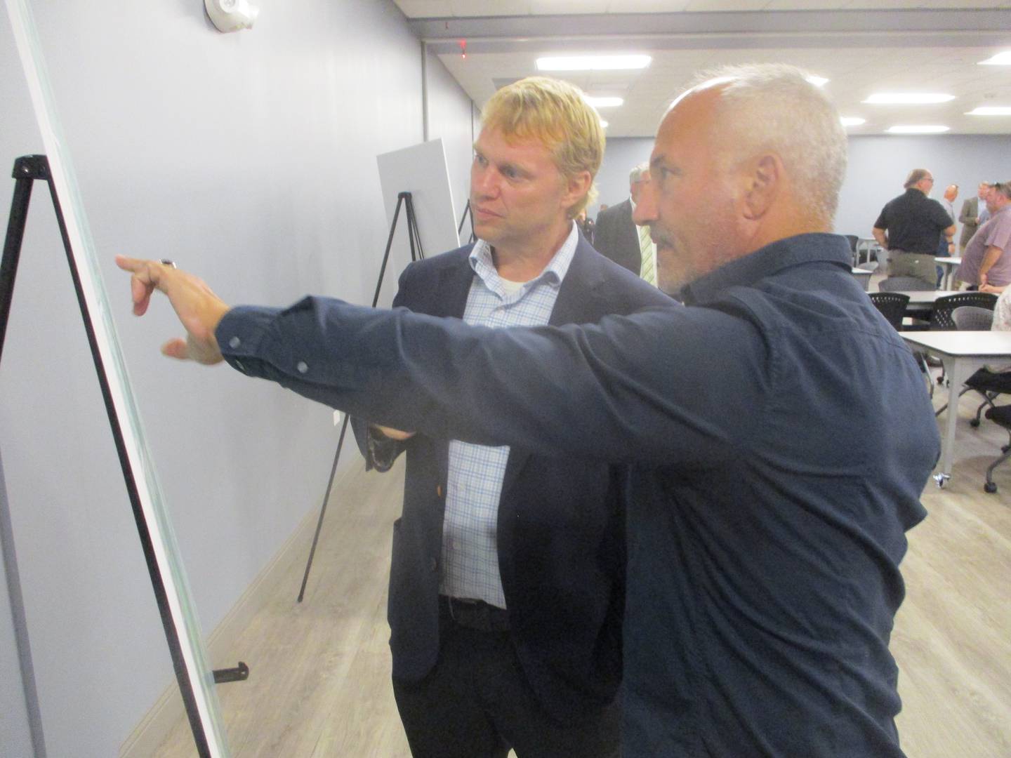 Plainfield Mayor John Argoudelis (right) discusses plants for a Lockport Street/Airport Road interchange at Interstate 55 with Steven Schilke, bureau chief of programming for the Illinois Department of Transportation at a public hearing for the proposed interchange on Wednesday. Sept. 15, 2024