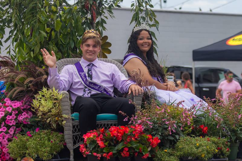 Petunia Festival King Tyler Zepezauer and Petunia Festival Queen Tya Collins wave to the crowd during the parade Sunday afternoon in Dixon.