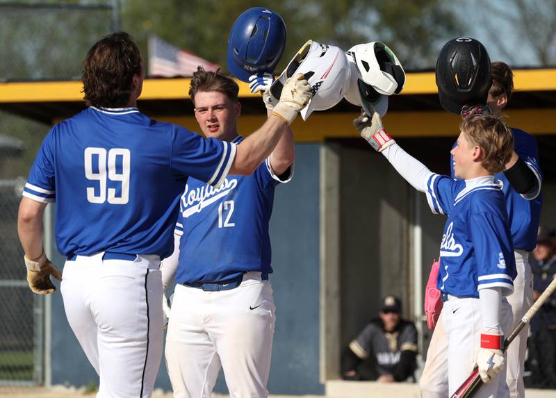 Hinckley-Big Rock's Martin Ledbetter (left) is congratulated by teammates as he arrives at the plate after hitting a 3-run homer Tuesday, April 29, 2025, during their game at Hiawatha High School in Kirkland.