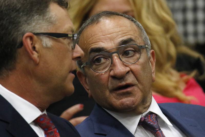 McHenry County Board Chairman Mike Buehler, left, and Crystal Lake Mayor Haig Haleblian speak in the audience as they await President Joe Biden's visit to McHenry County College on Wednesday, July 7, 2021 in Crystal Lake.