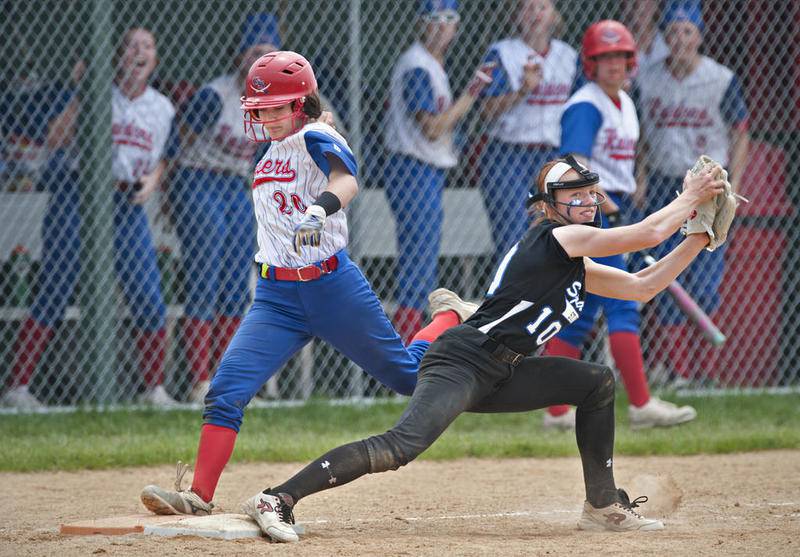 Glenbard South's Catherine Karr is out on a close play as St. Francis first baseman Tarin Malloy (10) makes the putout on June 1.