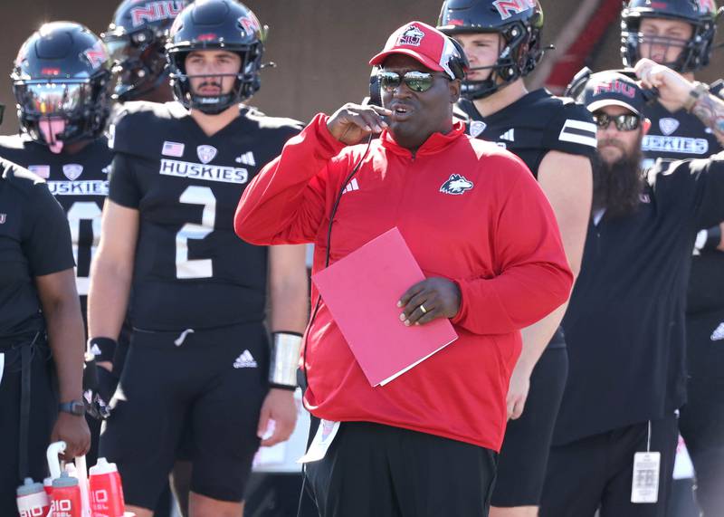 Northern Illinois head coach Thomas Hammock  talks to the coaches in the booth during their game against Southern Illinois Saturday, Sept. 9, 2023, in Huskie Stadium at NIU in DeKalb.