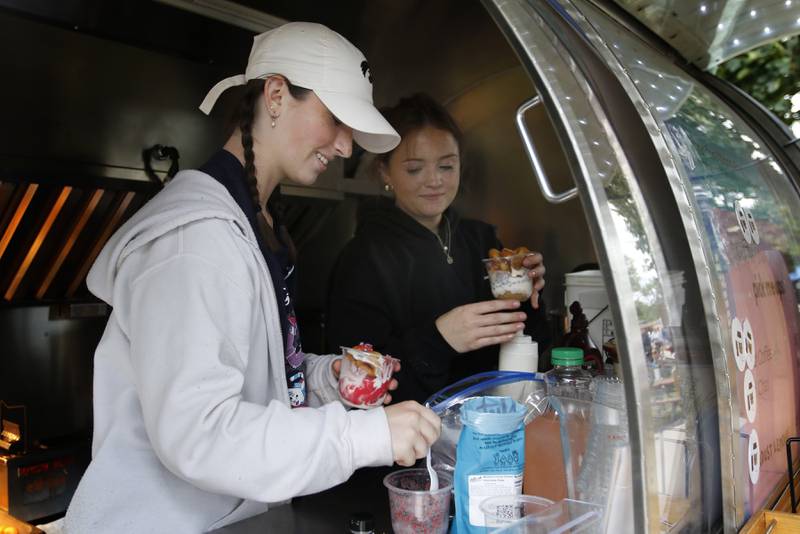 Abby Kirk and Kennedy Market make  sundaes at Joe & Dough during the Ice Cream Fest on Friday, Aug. 9, 2024, at Crystal Lake’s Main Beach. The second annual event featured music, ice cream venders and an ice cream eating contest.