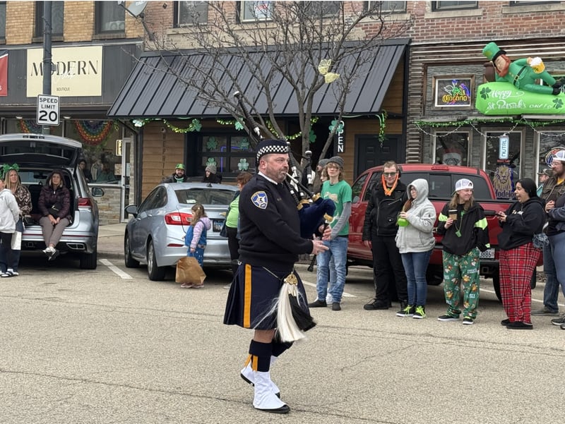 La Salle Police Chief Jason Stubler leading the St. Patrick's Parade playing bagpipes.