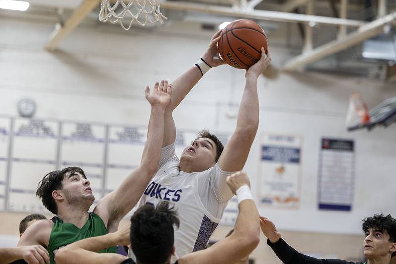 Dixon’s Matthew Warkins pulls down a rebound against North Boone Tuesday, Jan. 10, 2023.