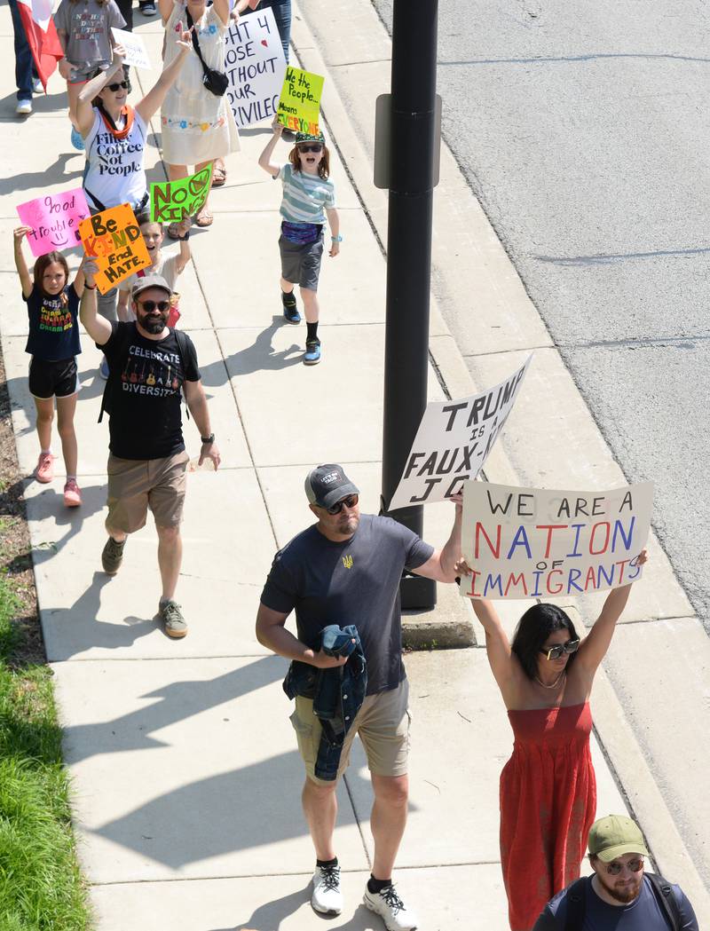 Approximately 1,200 people walk from Elmhurst City Hall to Glos Memorial Park while participating in the nationwide No Kings Day Rally showing support for immigrants Saturday June 14, 2025.