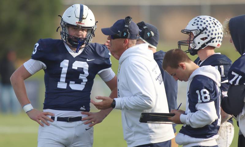 Cary-Grove’s Head Coach Brad Seaburg works with quarterback Jackson Berndt against Belvidere North in IHSA Class 6A quarterfinal playoff football action on Saturday, Nov. 16, 2024, at Al Bohrer Field on the campus of Cary-Grove High School in Cary.