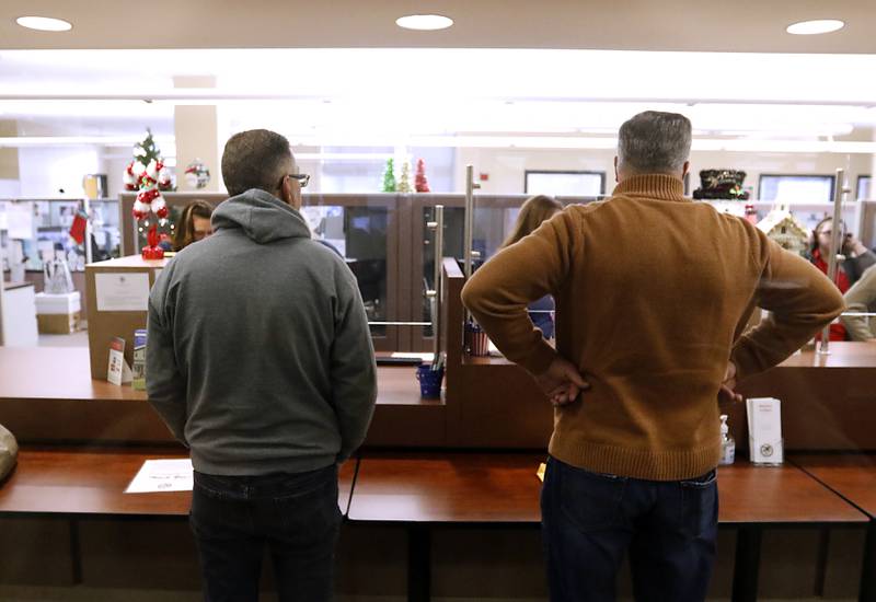 McHenry County Chairman Michael Buehler, left, and John Collins, who is running for County Board, file their candidate forms on Monday, Nov, 27, 2023, at the McHenry County Clerk's Office in Woodstock. Monday was the first day for candidates to file ahead of the March primaries.