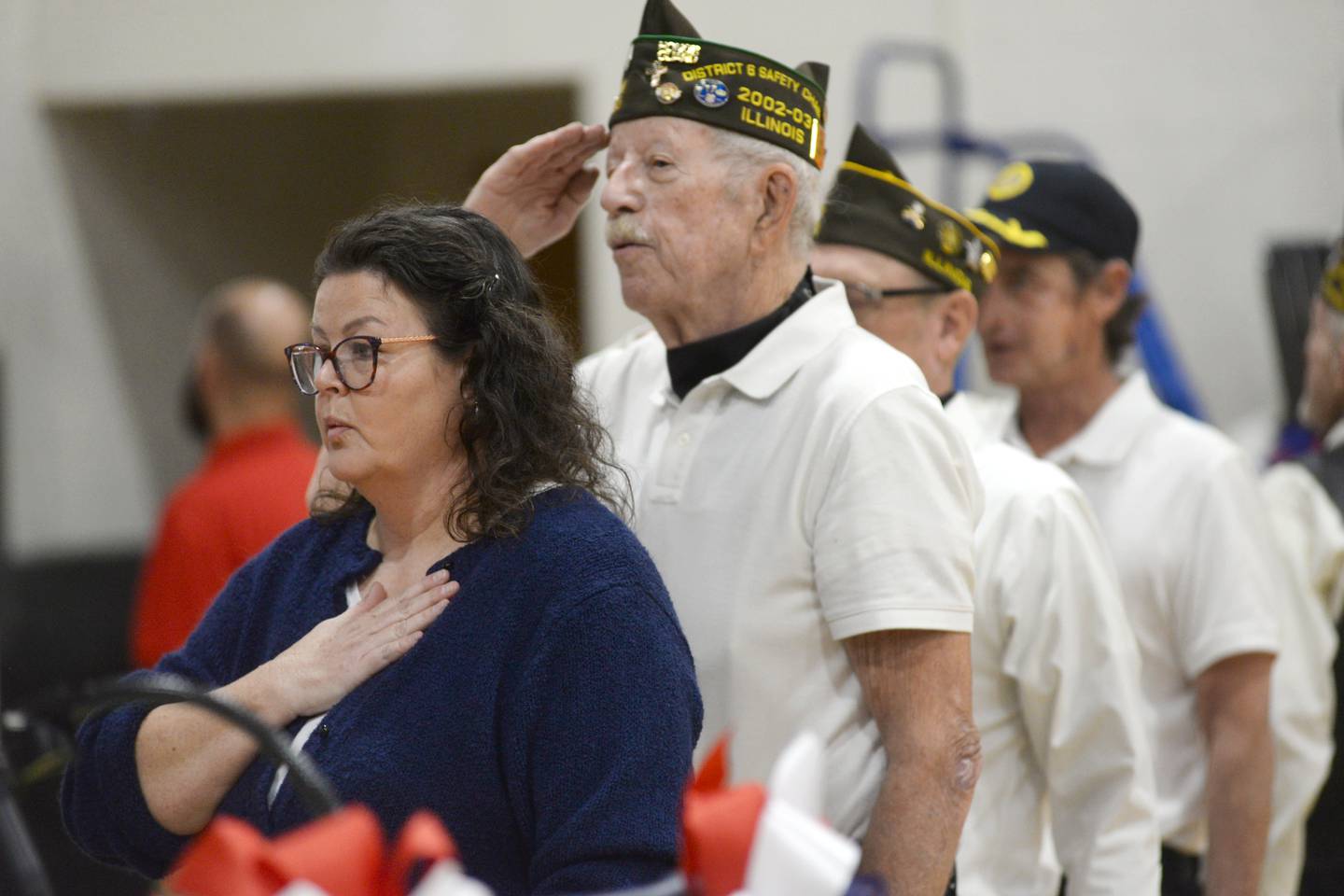 Veterans Becky Davis (left) and John Foxley listen to the National Anthem at the start of the Veterans Day ceremony at Centennial Grade School in Polo  on Monday, Nov. 11, 2024.
