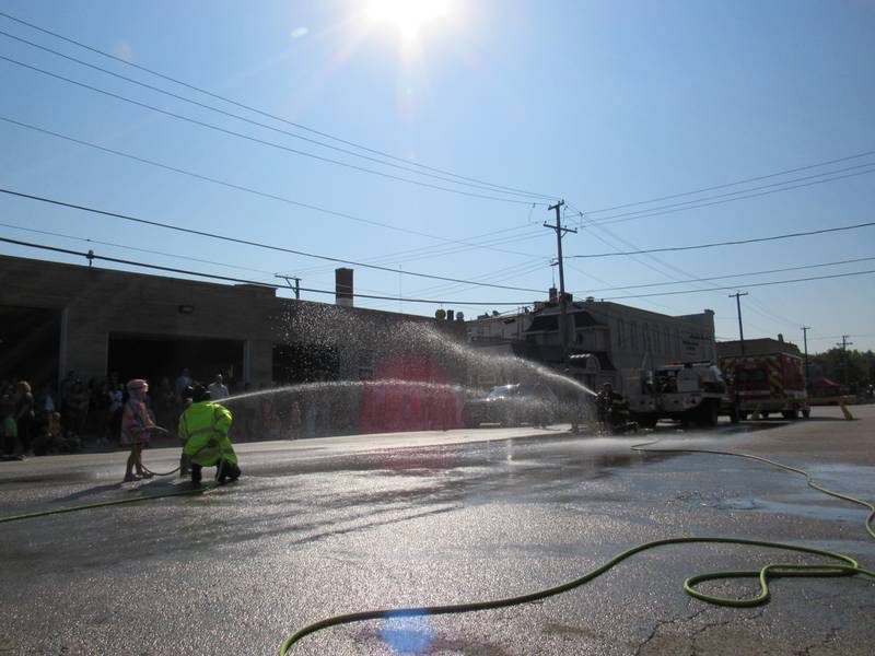 Sadie (left) listens as the firefighter provides guidance on how to win.