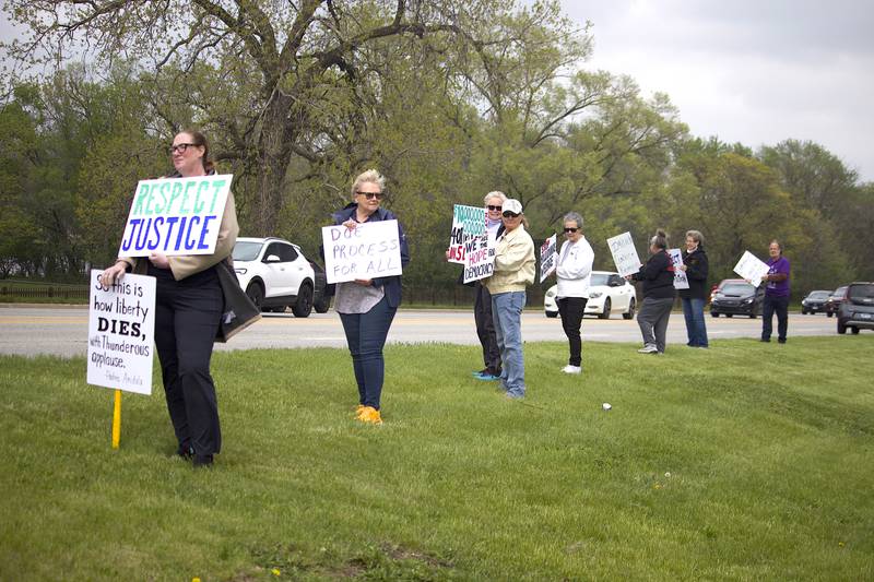 People participating on Thursday, May 1, 2025, at a democracy rally in Joliet. More than 20 people attended the rally held near the busy West Jefferson Street and the Joliet Regional Airport.