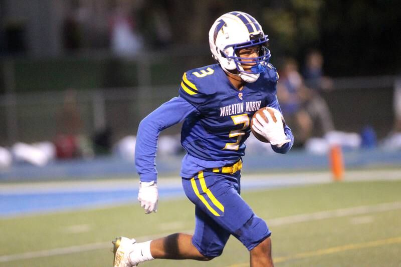Wheaton North’s A.J. Lyons returns a kick-off during a game against St. Charles North in Wheaton on Friday, Sept. 8, 2023.