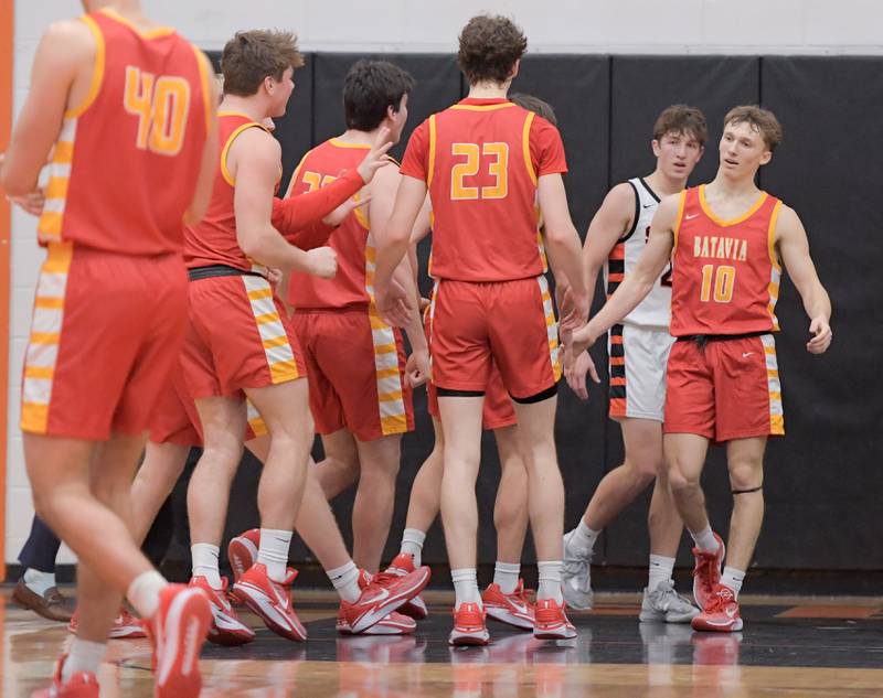 Batavia celebrates with Nate Nazos (10) after he scored what would be come the winning basket over Wheaton Warrenville South in Wheaton on Saturday, January 6, 2024.