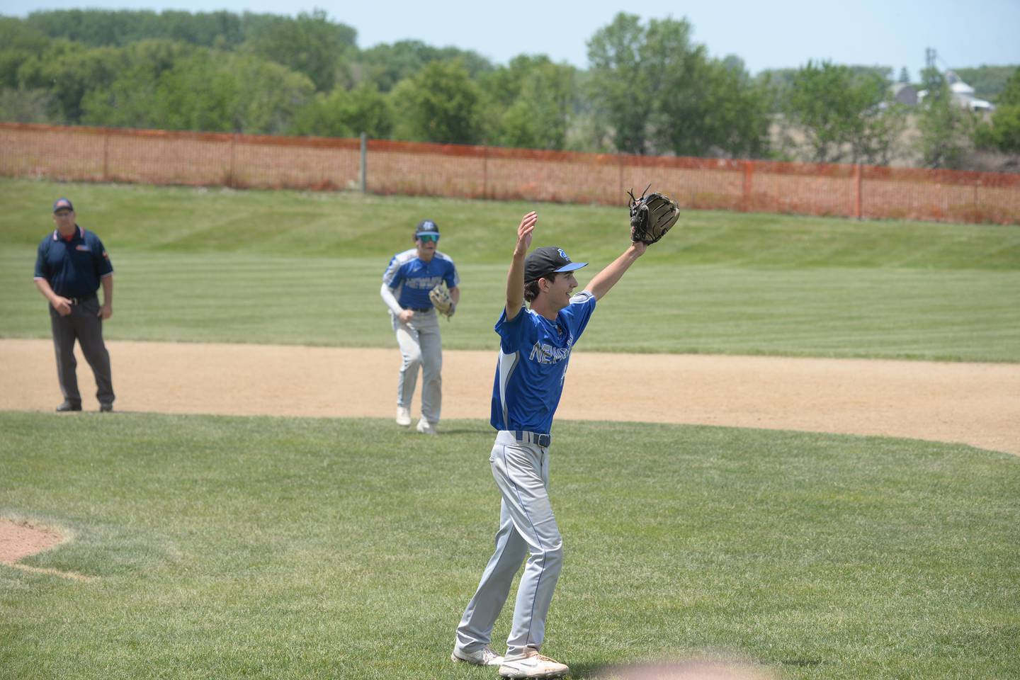 Newman's Kyle Wolfe begins to celebrate as the left fielder makes the final out against Dakota in the Comets' 10-7 championship win at the 1A Pearl City Sectional on Saturday, May 27.