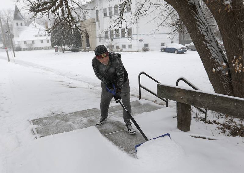 Brandon Yankowski shovels the sidewalk on Wednesday, Feb. 12, 2025, along Broadway Street in Richmond. A winter storm is bring heavy snow to the McHenry County area.
