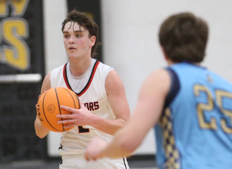 Woodland's Nolan Price dribbles up the court against Marquette's Caden Durdan during the Tri-County Conference Tournament championship on Friday, Jan. 30, 2026 at Putnam County High School.