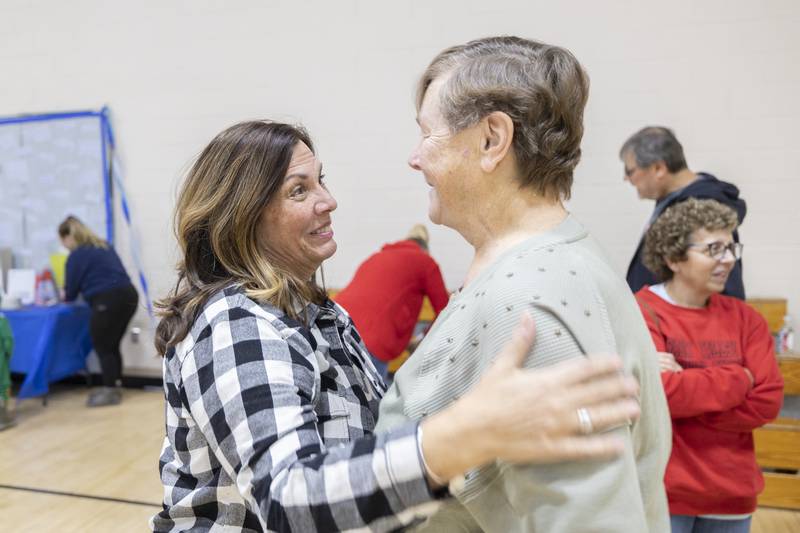 LuAnn McFadden (left) of Rock Falls gives  Deb Mortonson a hug Wednesday, Dec. 17, 2025, in congratulations of her retirement.