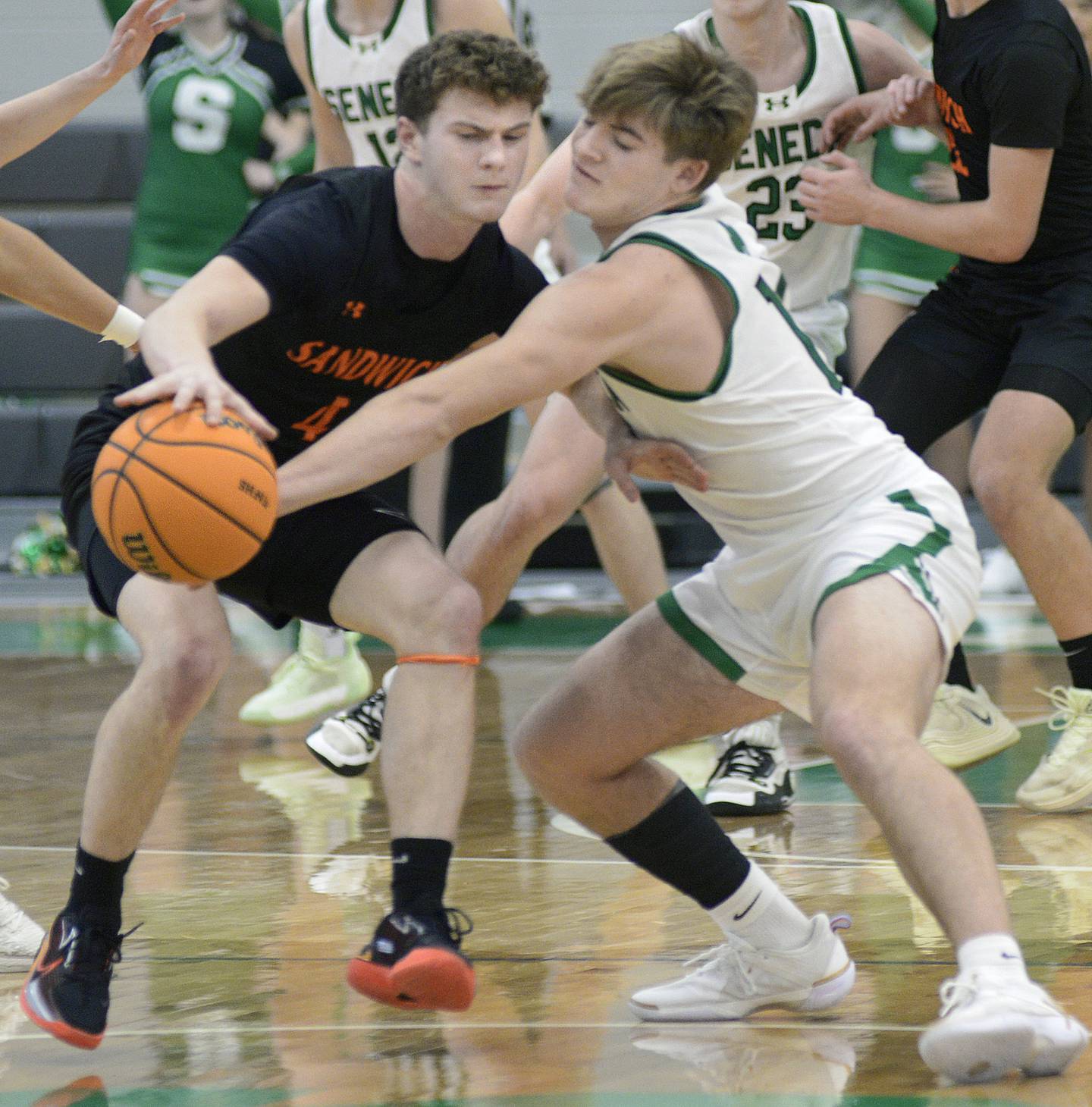 Seneca’s Cam Shriey knocks the ball away from Sandwich’s Griffin Somolock in the 2nd period Saturday during the MLK Shootout at Seneca.