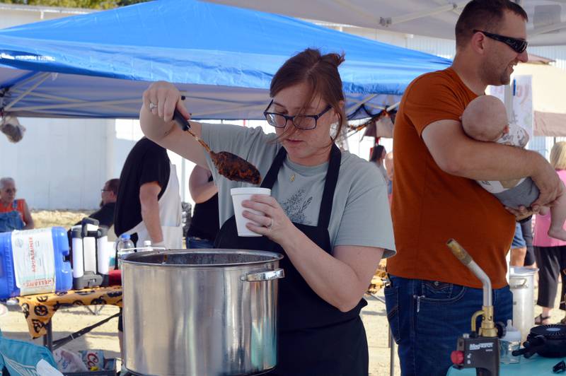 Amanda Shuman, of Polo, serves up a bowl of pumpkin chili during Polo's Chili Cook-Off on Sept. 30, 2023. The cook-off was held in the city-owned lot next to the Shell station; it was the first time the event has taken place since 2019.