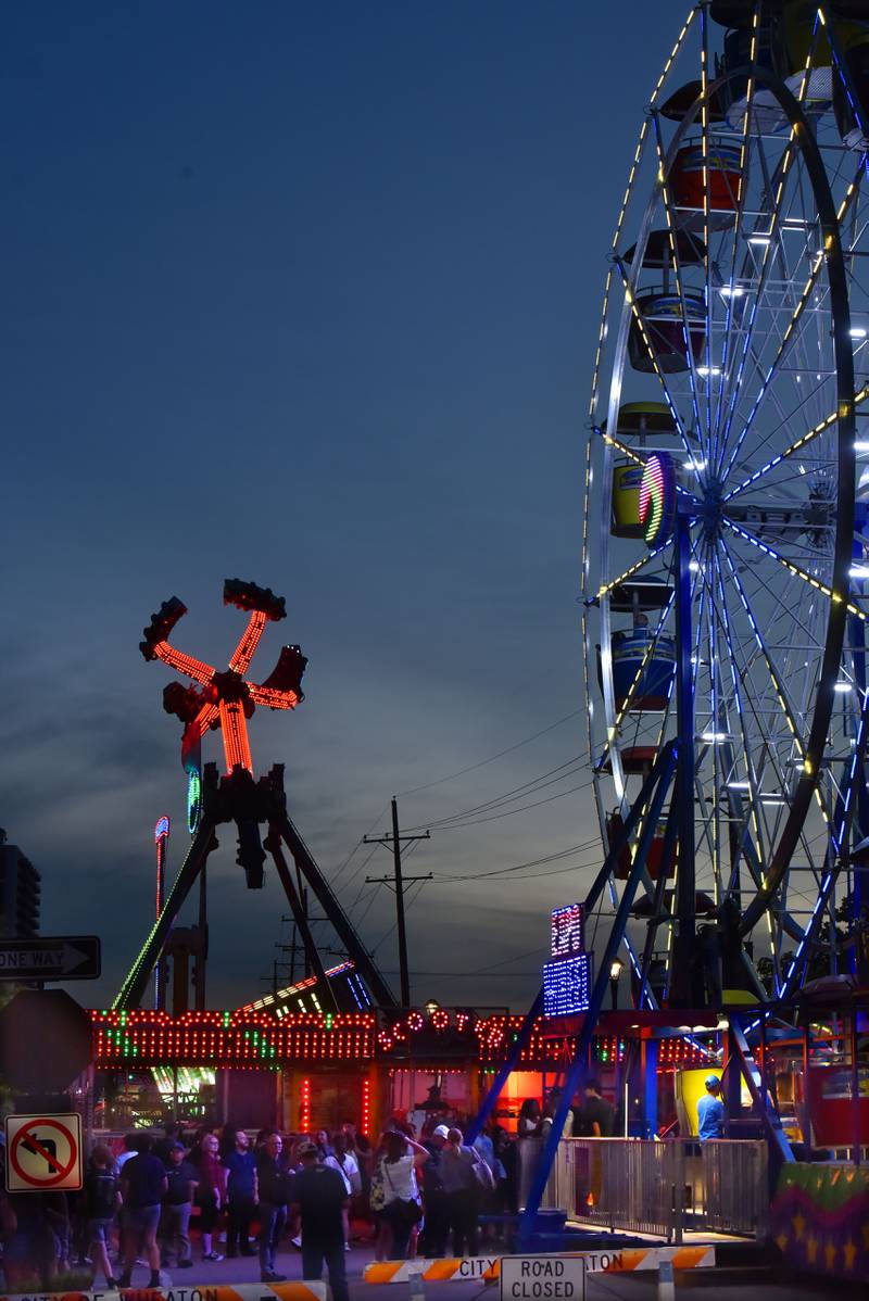 Carnival rides attract people to Liberty Drive at the Cream of Wheaton summer festival in downtown Wheaton on Thursday, May 30, 2024.