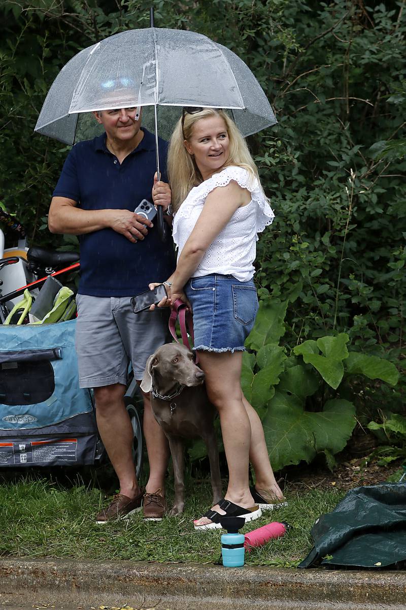 Robert and Alicia Rugala, of Cary watch the parade under an umbrella with their doge Layla, on Sunday, July 7, 2024, during Crystal Lake’s annual Independence Day Parade on Dole Avenue in Crystal Lake. This year’s parade featured close to 100 units.