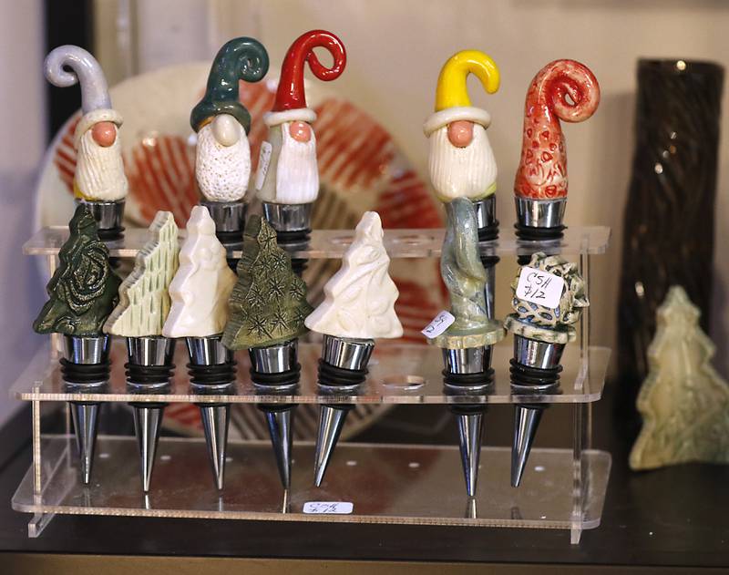 Holiday themed wine toppers made by Chris Howatt onThursday, Dec. 19, 2024, at Artisans on Main in Woodstock. Several of the artists have holiday themed items for sale.