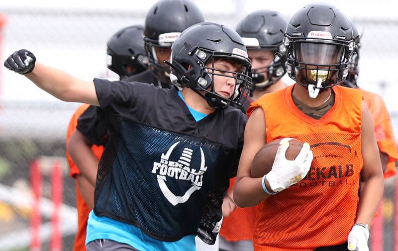 DeKalb players work on a ball stripping drill Monday, Aug. 8, 2022, at the school during their first practice ahead of the upcoming season.