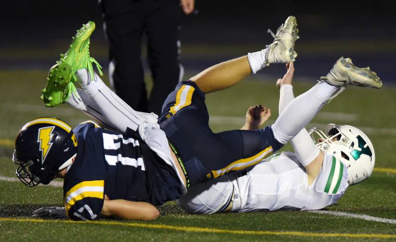 Joe Lewnard/jlewnard@dailyherald.com
Glenbrook South's Daniel Devine, left, knocks down York quarterback Sean Winton on a play that was called for an interntional grounding penalty during a football game played in Glenview, Ill. on Friday, Aug. 25, 2023.