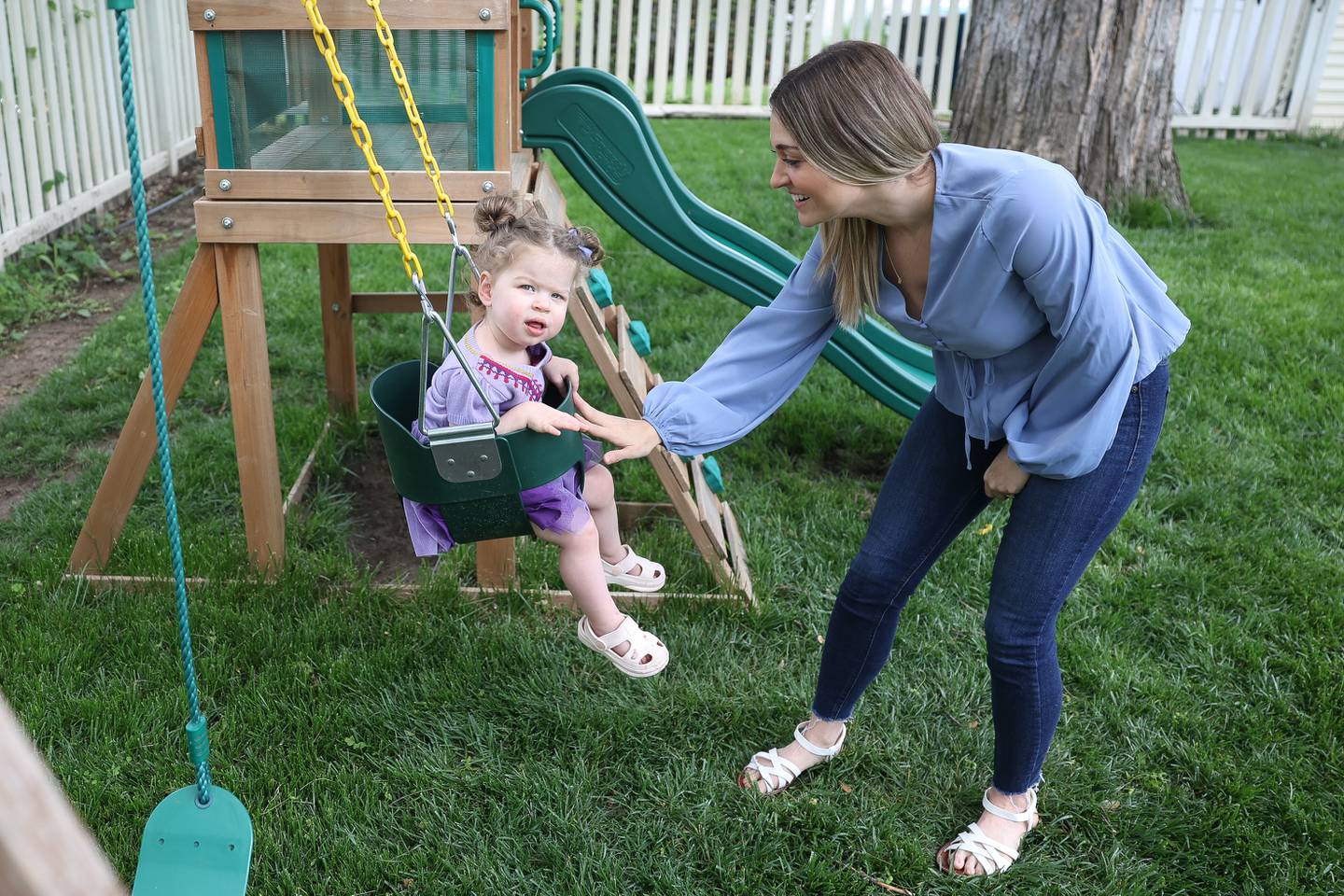 Kristin Dziuban Walls, who suffered a stroke on Thanksgiving day last year, plays with her Mila, 1, in her backyard on Friday, May 10, 2024 in Morris.