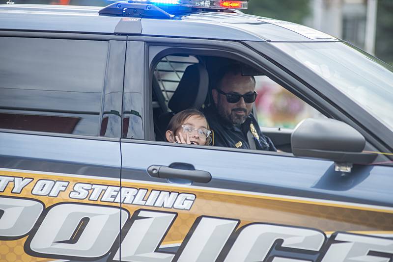 Sterling Police Chief Alex Chavira and his favorite junior officer , his 8-year-old niece, Vivienne Chavira,lead the Fiesta parade Saturday. Uncle Alex was the parade's grand marshal.