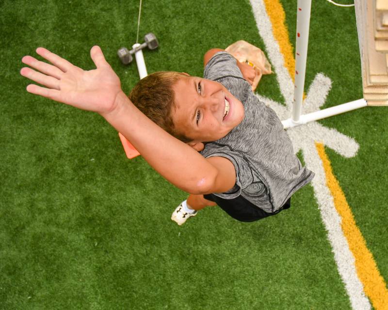 Ryan Frost, 9, of Downers Grove sees how high he can get in the standing vertical jump portion of the NFL Youth Flag Football Combine Day held at Doerhoefer Park in Downers Grove on Sunday Aug. 6, 2023.