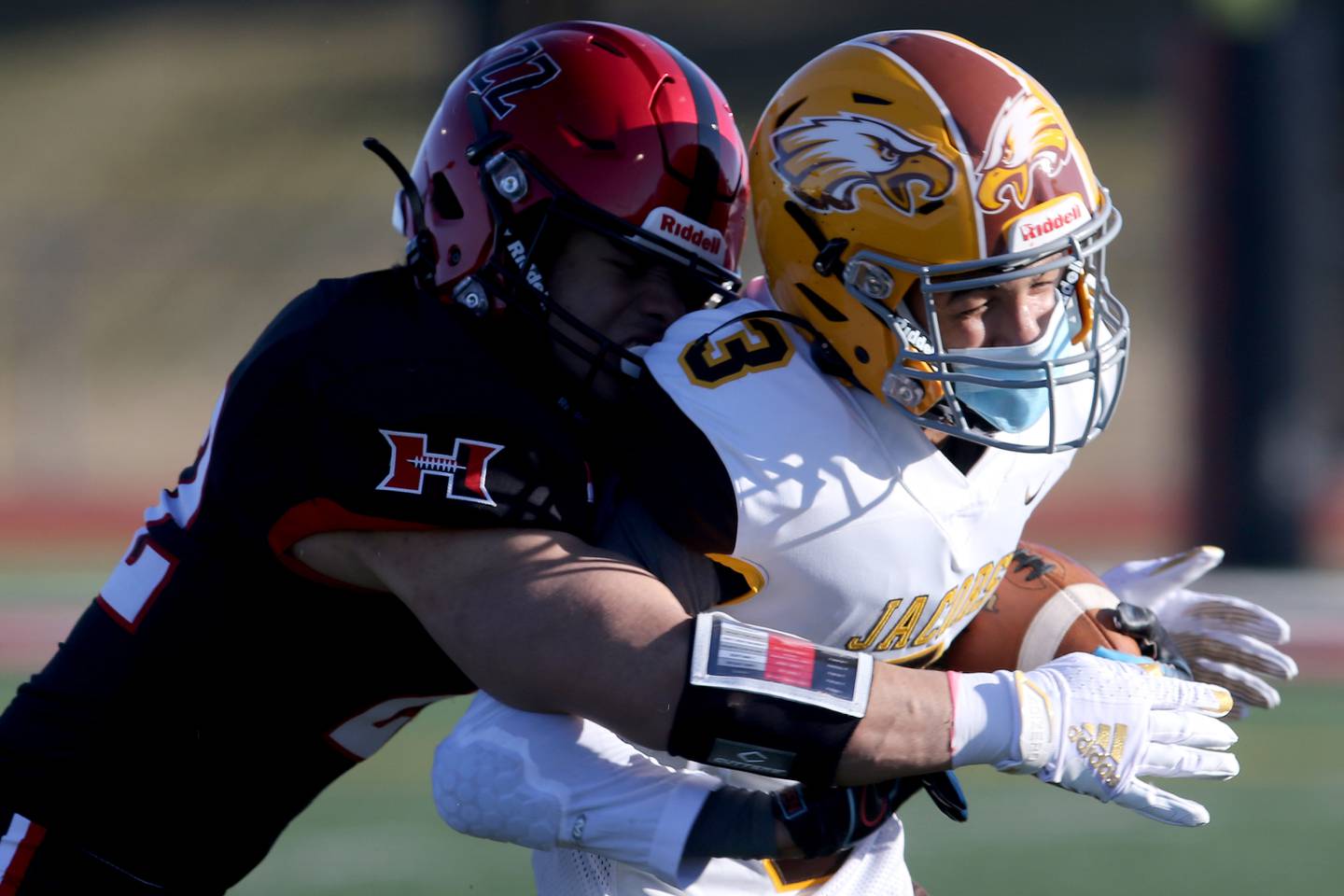Huntley's Christopher Medina, left, hits Jacobs' Jaiden LaRoss, knocking him out of bounds during their season opening football game at Huntley High School on Friday, March 19, 2021 in Huntley.