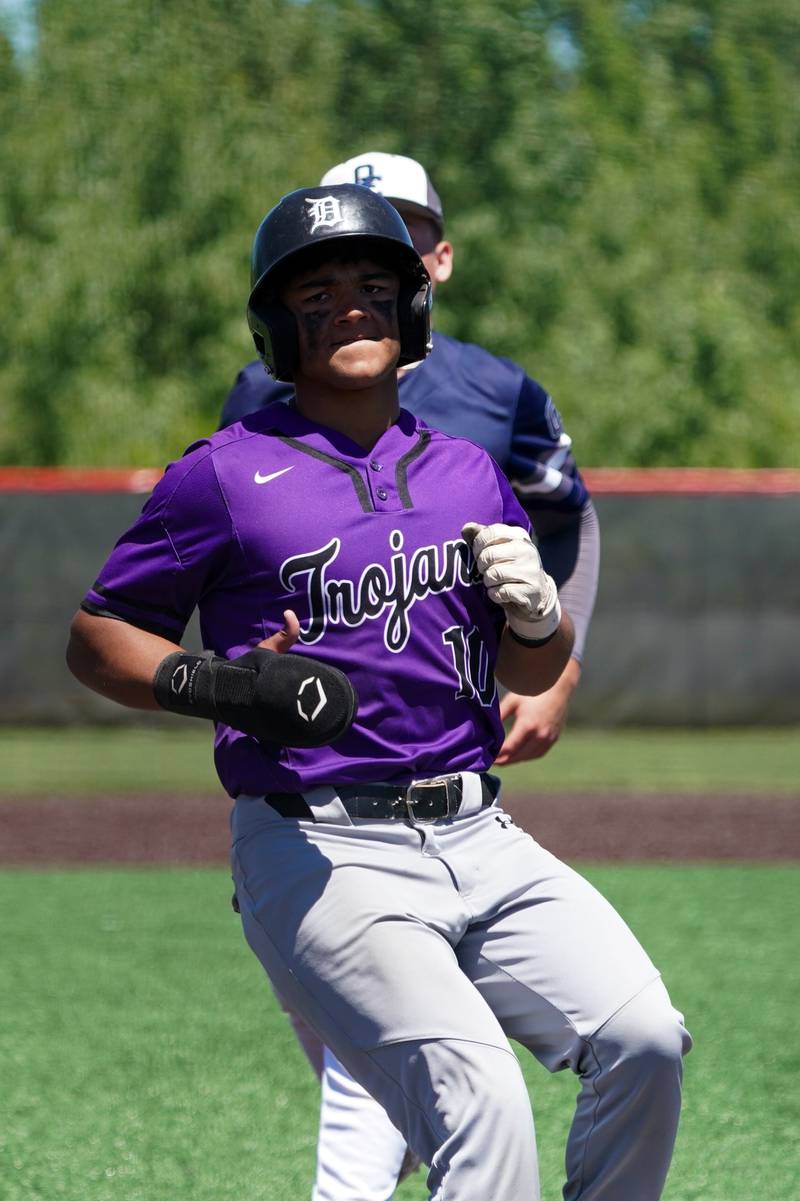 Downers Grove North's Edgar Santos (10) scores on a wild pitch by Oswego East during a 4A Bolingbrook Regional Championship baseball game at Bolingbrook High School on Saturday, May 25, 2024.