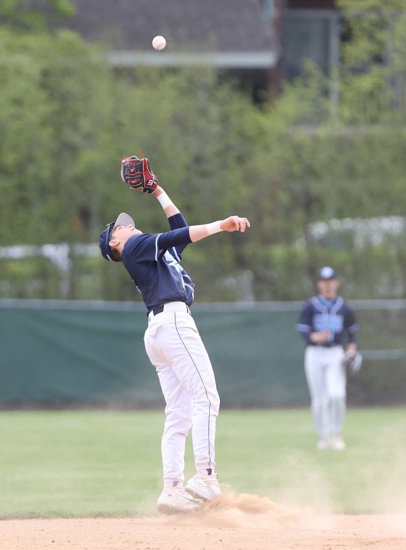Downers Grove South's Will Potter (6) grabs a pop-up during the varsity baseball game between Downers Grove South and Downers Grove North in Downers Grove on Saturday, April 29, 2023.
