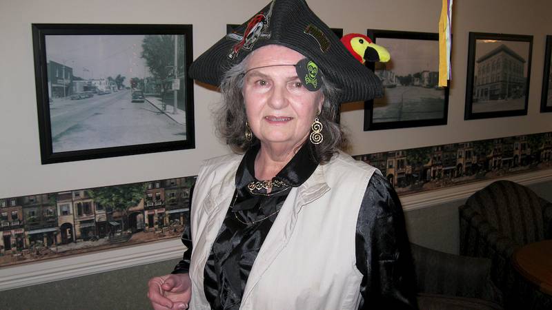 Linda Finger, a volunteer at Grand Victorian in Sycamore, dressed in pirate finery for the retirement home's first Halloween party on Oct. 17.