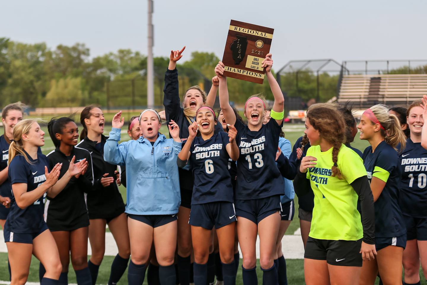 Downers Grove South celebrates with the Class 3A Addison Trail Regional final plaque after Downers Grove North.  May 19, 2023.