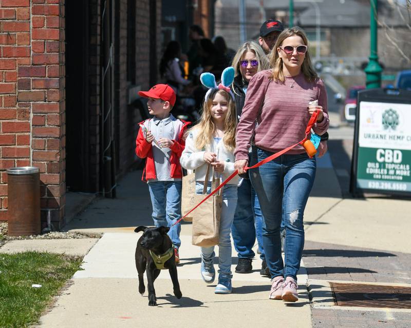 Korrin Santow of Brookfield along with her 6 month old lab, Steve, kids Autumn, 9, Ethan, 6, and Sister Jessica Lima of Montgomery keep up their tradition of coming to the annual Bunny Hop and stop at all the shops that provided candy and treats on Saturday April 12, 2025, held in downtown Oswego.
