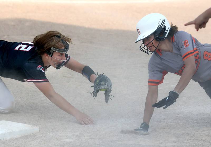 Dekalb's Calissa Hudson tries to get back into third but is tagged out by Auburn's Jalyn Yakey during their Class 4A regional game Wednesday, May 24, 2023, at DeKalb High School.
