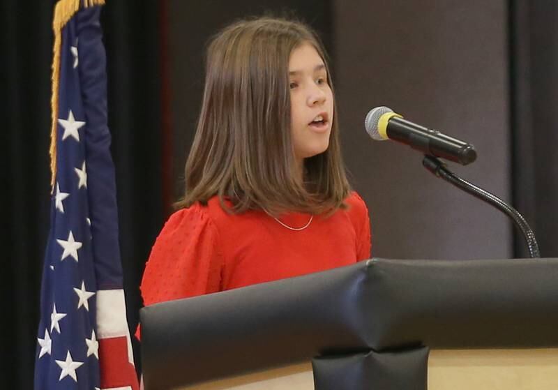 Parkside student Gabby Smith reads her poem "Forever in Your Debt during the annual Veterans Day Program on Monday, Nov. 11, 2024 at Parkside Middle School in Peru.