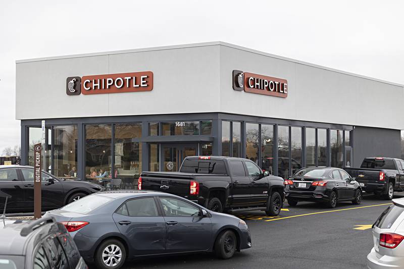 A steady stream of traffic moves through two drive thru lanes Friday, Dec. 29, 2023 at Dixon’s Chipotle. Business appeared to be going swift and steady.